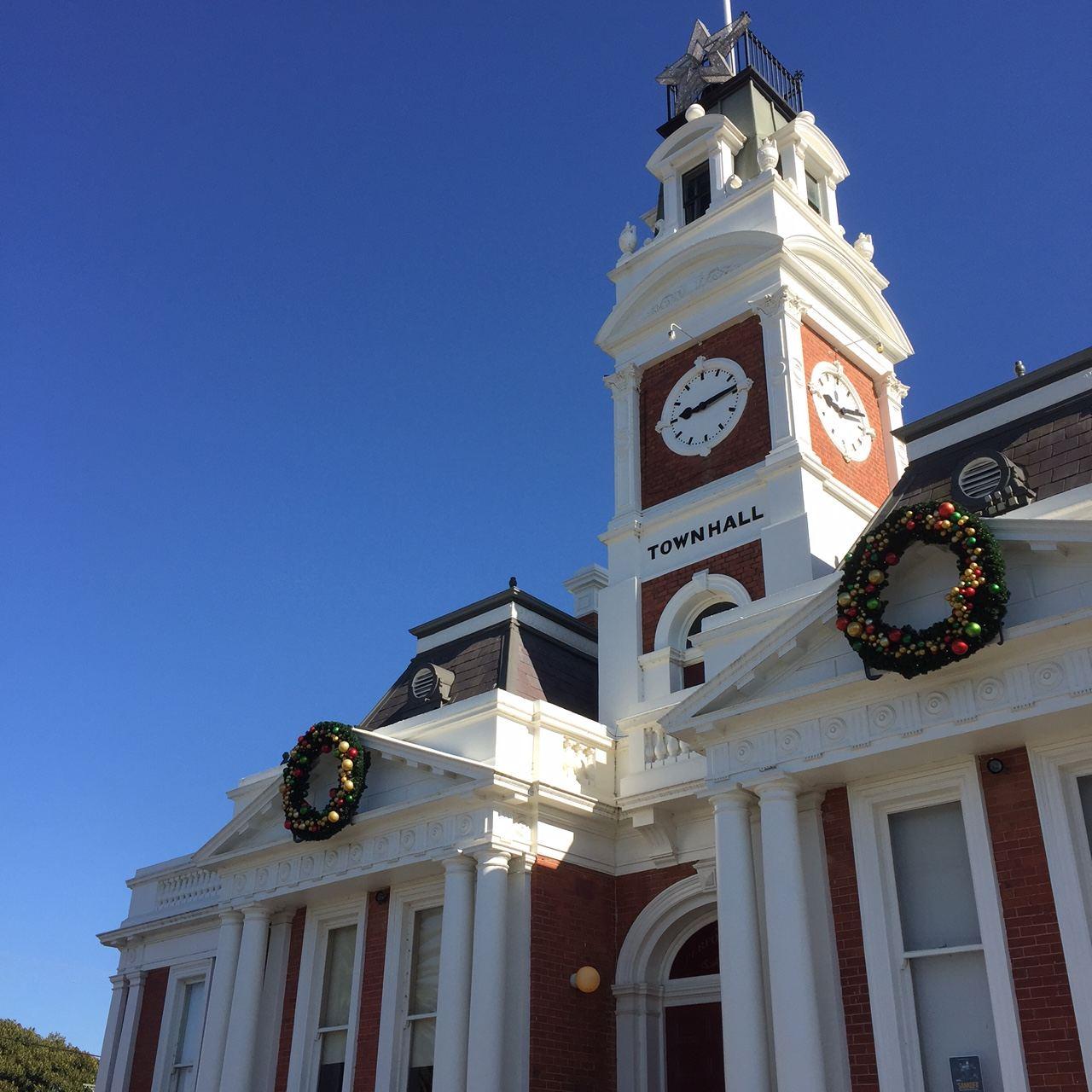 Town Hall building with Christmas wreaths on its towers