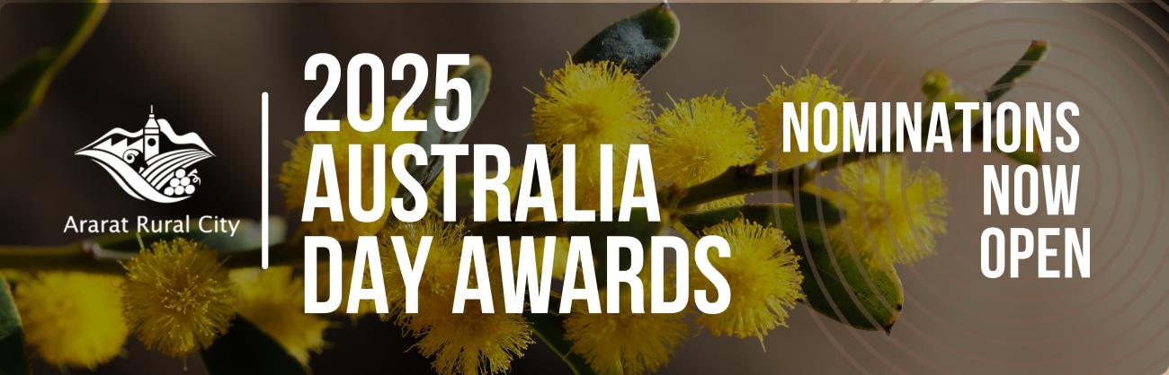 Close-up of yellow Australian wattle plant with details of the 2025 Australia Day Awards nominations in text