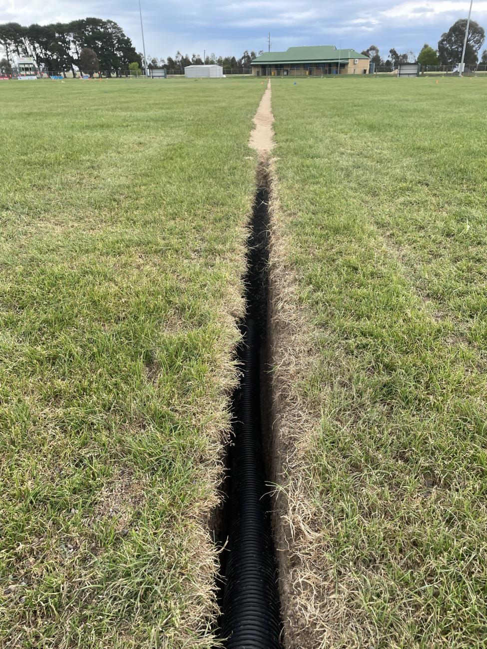 Large green oval area with deep channel running through