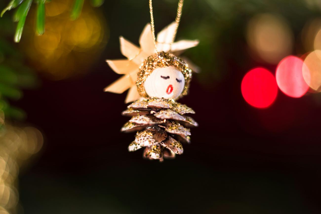 Close-up of Christmas tree ornament of a little angel singing carols